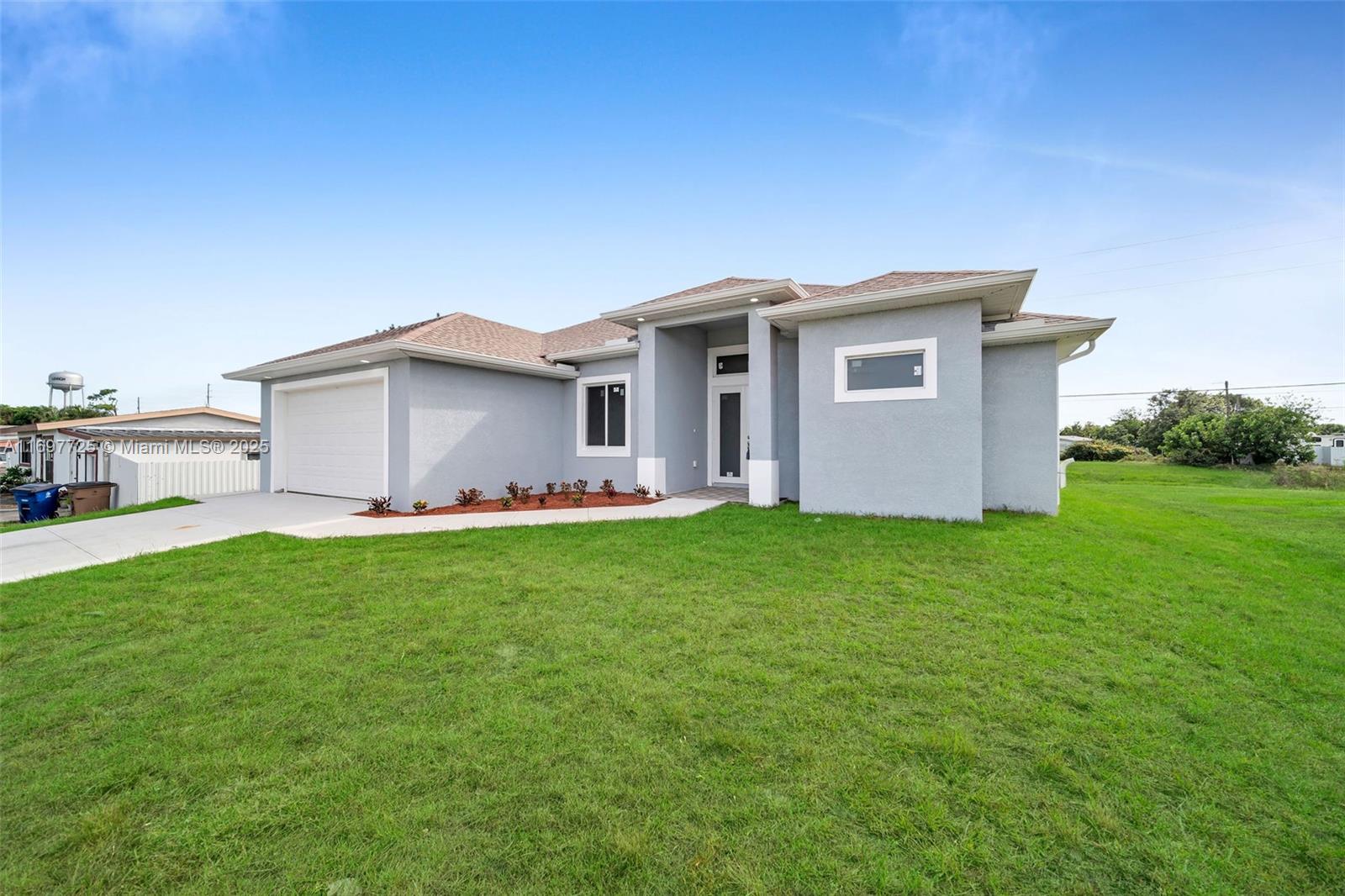 $10,000 in closing cost. Welcome to your beautiful new luxury home in the heart of Lehigh Acres with city water! This lovely property offers over 1,700 square feet of space, featuring three bedrooms, three bathrooms, and a den that's great for an office or extra guest room. the poperty has tile floors that flow throughout the home. The kitchen has shiny quartz countertops and plenty of cabinets for all your needs. Safety and comfort are key here, with impact doors and windows. The large lanai is perfect for outdoor gatherings, making it a great spot to relax and entertain friends and family.