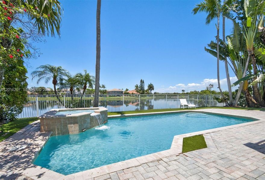 Welcome to your ultimate Pembroke Pines retreat. Step outside to a private oasis featuring a sparkling pool set against a serene lake backdrop, complete with a fenced yard and a partially covered paver patio. Inside, high ceilings and plantation shutters create an immediate sense of scale and light. This expansive floor plan offers 6 bedrooms and 3 full baths, including a convenient full bedroom and bathroom on the first floor. The upgraded kitchen shines with granite countertops and stainless steel appliances, while the formal dining room features elegant coffered ceilings. Retreat to the primary suite, which boasts dual closets, an upgraded marble bath, and a private balcony overlooking the water. Practicality meets luxury with a spacious three car garage and a laundry room complete with a sink. Living here means enjoying five-star, resort style amenities: guard gated, a massive clubhouse, fitness center, multiple pools, and sports courts. The location is elite. You are under four miles from I-75, Costco, Whole Foods Plaza, and the Shops at Pembroke Gardens mall, hospitals, parks, and golf. This property delivers the perfect combination of space, luxury, and location and is more than just a house; it is the vibrant lifestyle you have been waiting for.