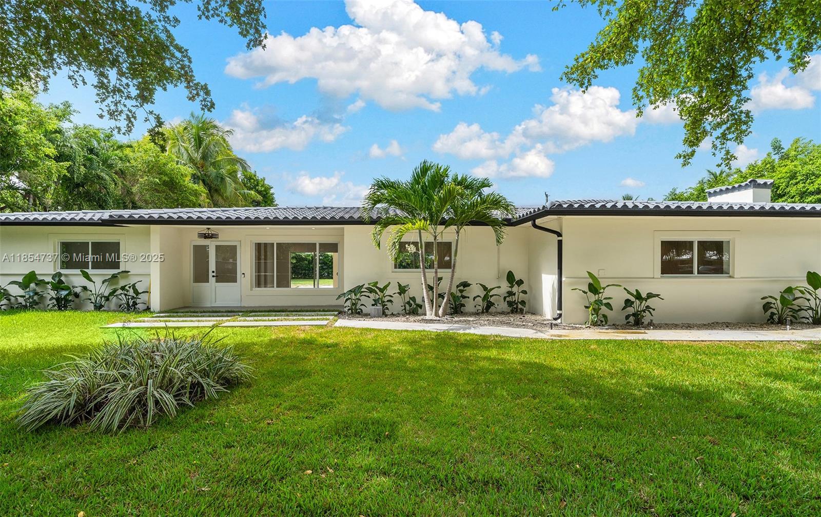 Completely remodeled 4 bed / 3 baths home in the heart of Pinecrest, crafted with unique, top-quality materials—can’t miss the opportunity to live in a just remodeled home. 2,810 sq.ft. under ac A as per appraisal on a 17,380 sq.ft. lot. All-new plumbing, electrical, roof from 2018, and all impact windows/doors. The primary suite offers a spacious built-in closet and luxurious bath. A central hallway connects two bedrooms sharing a full bath, plus an additional large bedroom with its own en-suite bath. The state-of-the-art kitchen features unique finishes and abundant storage. Enjoy a generous covered gallery, 625 sq.ft. detached A/C flex space, and a two-car covered carport, all in an excellent Pinecrest location near top-rated schools, parks, shops, and dining.