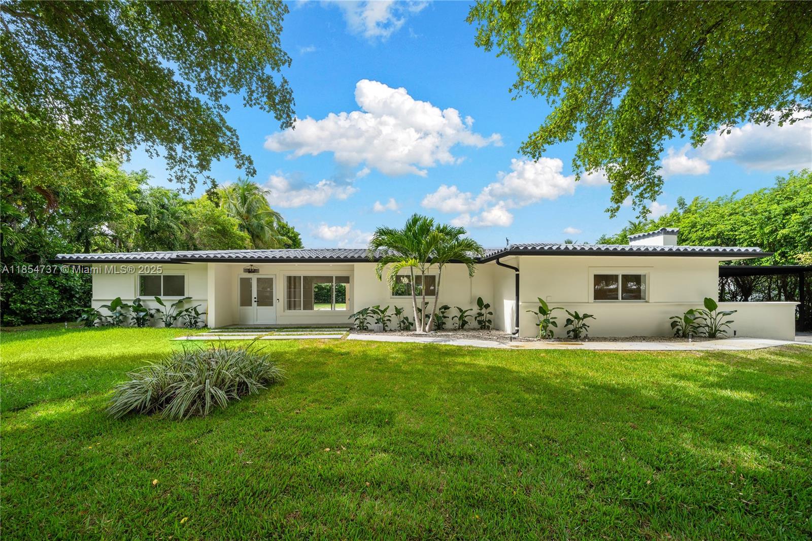 Completely remodeled 4 bed / 3 baths home in the heart of Pinecrest, crafted with unique, top-quality materials—can’t miss the opportunity to live in a just remodeled home. 2,810 sq.ft. under ac A as per appraisal on a 17,380 sq.ft. lot. All-new plumbing, electrical, roof from 2018, and all impact windows/doors. The primary suite offers a spacious built-in closet and luxurious bath. A central hallway connects two bedrooms sharing a full bath, plus an additional large bedroom with its own en-suite bath. The state-of-the-art kitchen features unique finishes and abundant storage. Enjoy a generous covered gallery, 625 sq.ft. detached A/C flex space, and a two-car covered carport, all in an excellent Pinecrest location near top-rated schools, parks, shops, and dining.