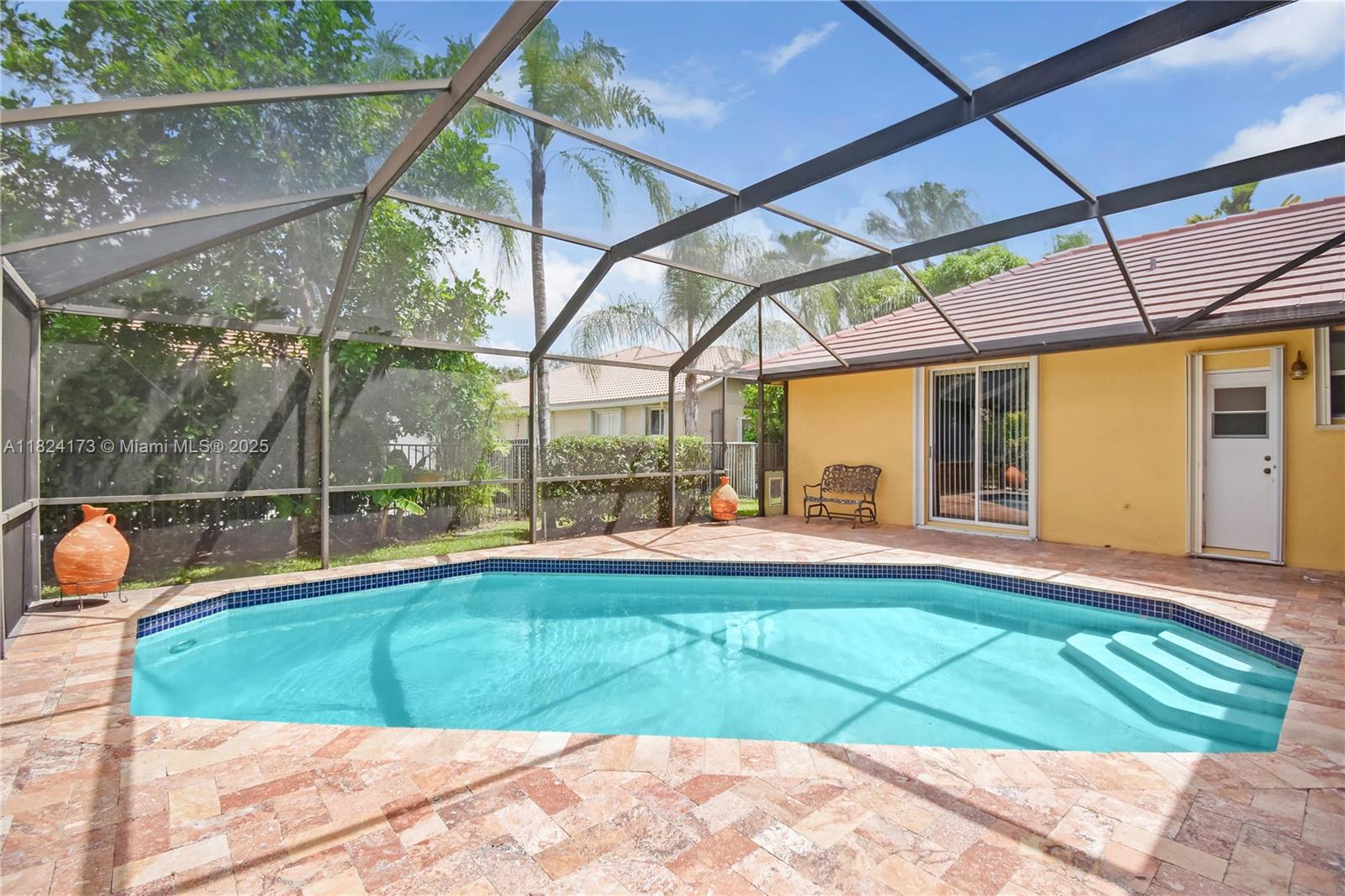 Impeccably maintained one-story home with a screened pool, located in the prestigious gated community of Weston Hills CC. Featuring 5 Bed, 3.5 Baths, and a custom split floor plan, this residence offers 2,566 SF of bright, open living space with soaring ceilings and elegant finishes throughout. Enjoy the screened patio with a sparkling pool and travertine marble deck, including a full cabana bath. With a new roof (2022), newer A/C (2020), accordion shutters, and a paver driveway, this home is move-in ready. Weston Hills CC offers resort-style living and is home to Weston’s premier golf course. Embrace the exclusive Weston lifestyle, just moments from A+ schools, upscale dining, luxury shopping, parks, and South Florida’s beautiful beaches.