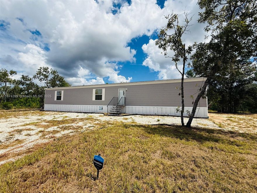 This brand-new 2024 single-wide mobile home sits on a spacious 0.67-acre corner lot in the quiet town of Interlachen, FL. Designed with comfort and functionality in mind, this home offers an open-concept layout that’s perfect for entertaining and enjoying. Everything from quick meals to holiday gatherings easy and enjoyable. Extras you’ll love: Simply Safe security system with 2 cameras for peace of mind.10-year transferable warranty for confidence in your investment. New well and septic system (2024) for hassle-free living. Life in Interlachen offers a peaceful, small-town atmosphere with all the essentials close by. Dream location for anyone who loves fishing, boating, hiking, or outdoor adventures. You’ll even be close to Hog Waller ATV Campground & Resort.5-ton AC. Seller is motivated!