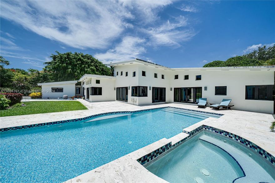 Stunning Acre Estate! This stunning Estate boasts a double split floor plan featuring 5 bedrooms and 4 bathrooms, including separate private in-law quarters. Enjoy the expansive swimming pool, spa, and the largest lot in the neighborhood. The luxurious master bedroom suite offers a view of the pool and Patio, custom walk-in closets, and a remarkable master bathroom. A must-see! The Property has 5,169 square feet of living area on an over 47,000 square foot lot.