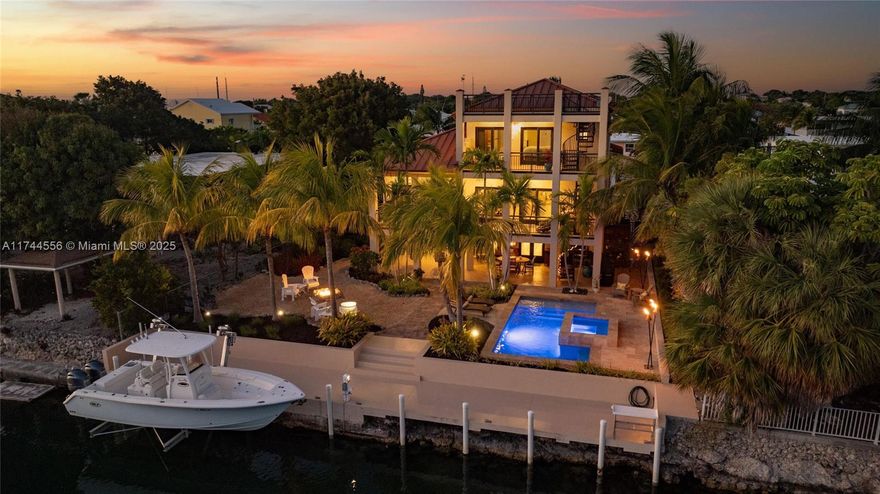 Stunning 3-Story Canal front Oceanside Home with the Trifecta of Amenities: Pool, Elevator & 70' Concrete Dock! Welcome to your dream home in the Florida Keys! This 3-bedroom, 2-bathroom canal front property offers the perfect blend of luxury, comfort, and waterfront living. Nestled in a highly sought-after oceanside location with direct ocean and bay access, this residence is a boater's paradise, featuring a 70-foot concrete dock complete with a boat lift, ready for your water adventures. Step into a light-filled, open-concept living space with expansive sliding glass doors that frame lush tropical views and seamlessly connect to the outdoor balconies.