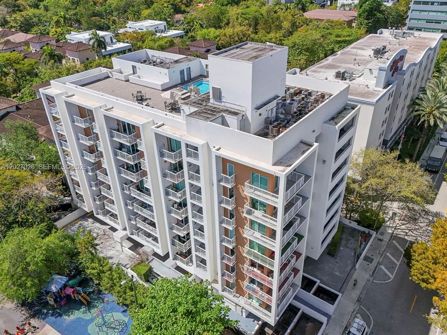 Perched on the fifth floor of Villaggio in the Grove, this coveted corner residence offers an experience rarely found at this price point in one of Miami's most storied neighborhoods. A true end unit with no shared party walls, the home commands sweeping sunrise views over the lush canopy of Coconut Grove - a living postcard visible each morning from a generous private balcony.
Inside, an open-concept layout flows effortlessly: granite kitchen with full appliance suite and eat-in bar opens to a light-filled living area extending to the outdoor terrace.
Resort-caliber amenities include a rooftop pool with lounge areas, fitness center, gated entry with intercom, and assigned parking, all moments from Coconut Grove's celebrated dining, boutiques, and cultural venues, with direct access to US-1 and Grove Central Metro.
