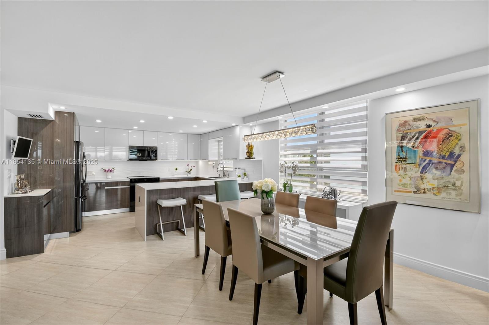 ENTER THIS COMPLETELY RENOVATED MODERN RESIDENCE IN THE HEART OF BAY HARBOR ISLAND & IMMEDIATELY & THROUGHOUT SEE THE BEST DIRECT WATER VIEWS OF THE INDIAN CREEK LAKE & ISLAND. THIS COVETED 2 BEDROOM/2 BATHROOM SPLIT PLAN HAS A NEW OPEN STATE OF THE ART GOURMET KITCHEN & ALL NEW BATHROOMS. THE FINEST FINISHES INCLUDE ALL NEW TILE FLOORS THROUGHOUT, ALL IMPACT GLASS WINDOWS, CUSTOM LIGHTING, HEATED POOL.