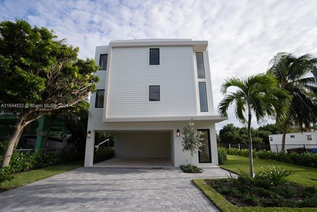 New construction between Tavernier & Isla Morada. Tasteful move-in ready tropical paradise spans 3 stories with 4 bedrooms, 3 and 1/2 bathrooms. Floor 1 carport for 2 cars, bedroom, bathroom, closet, & storage unit opening to covered terrace, pool, and outdoor kitchen. Floor 2, kitchen, living room, dining room, a laundry room, half bath, & terrace facing the waterway. Floor 3 includes master bedroom connected to a large bath with twin showers and vanity, walk-in closet, & outdoor terrace. The 2 additional bedrooms are identical in size & share a hallway bath. High-end appliances by Frigidaire, counter depth, hardwood cabinets, Italian style with Quartz countertops, Spaniard porcelain flooring. Lushes landscaping. 60ft of dock space, making it simple to head out to the beautiful waters.