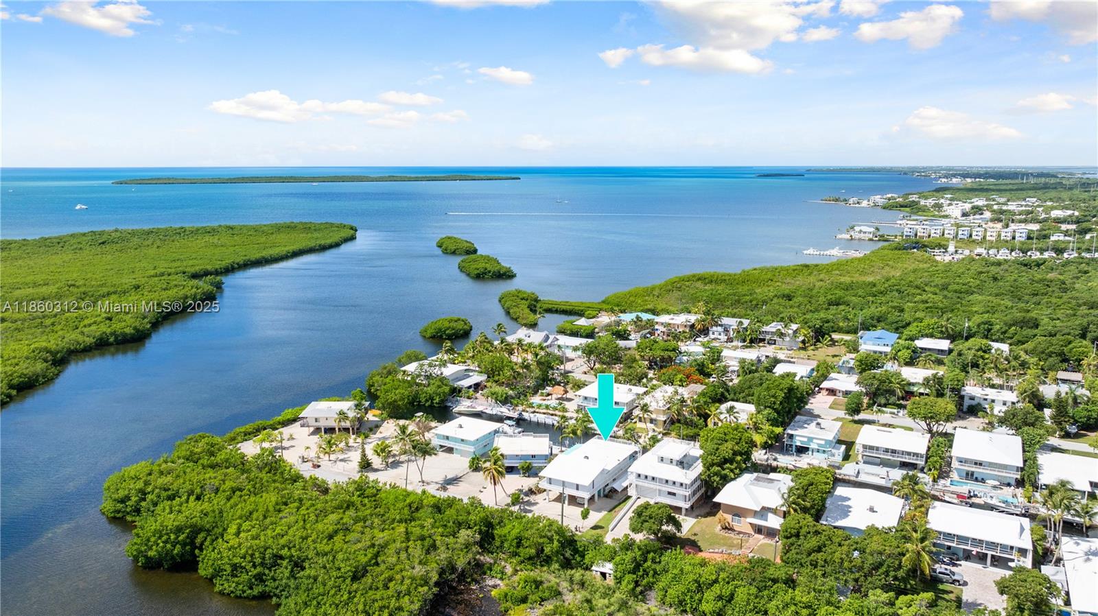 This exceptional all-CBS with concrete roof canal-front home offers direct ocean access to world-class fishing and diving, and is ideally located for an easy mainland commute. The permitted first-floor addition was added in 2001 and features 2 bedrooms, 1.5 baths, and a garage. The upstairs main living area has a recent 720 sq. ft. addition, creating a stunning master suite with a spacious bedroom and spa-like bath. The open-concept upper level blends living, dining, and kitchen spaces, along with additional bedrooms and 2 baths, perfect for hosting family and friends. Enjoy a 60-foot split-level concrete dock with step-down access for kayaks, paddle boards, and low-profile vessels. Entertain on the expansive porch or take advantage of ample parking for boats, RVs, and trailers