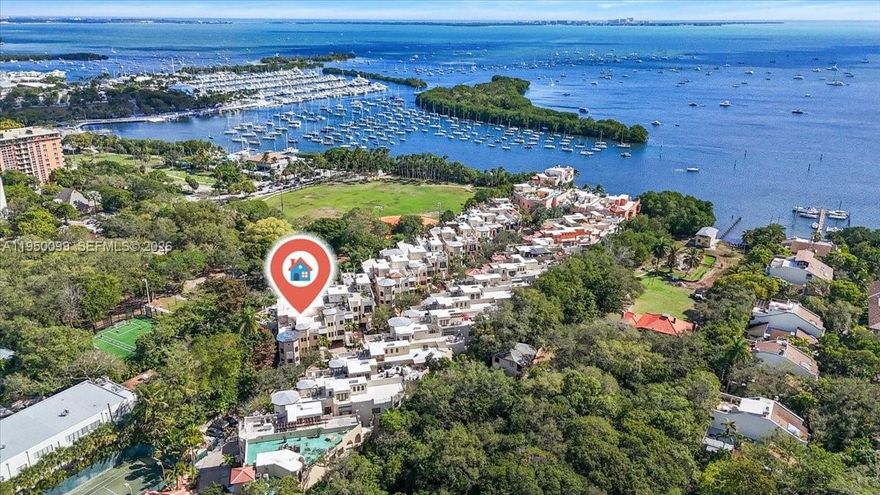 Cloisters on the Bay is a prestigious guard-gated bayfront enclave of only 40 homes in the heart of Coconut Grove. This rare four-level townhome offers 4 spacious bedrooms plus a dedicated office/den, 4.5 baths, a private elevator to all levels, and generous indoor–outdoor living including multiple balconies, a private walled garden, and a rooftop terrace overlooking Peacock Park. Flexible multi-level layout with large rooms, abundant natural light, marble floors, impact windows/doors, and a well-maintained original interior—ideal as a blank canvas for a full designer renovation. Private two-car garage plus two additional driveway spaces (4 spots total), a true luxury in the Grove. Community amenities include clubhouse, pool, tennis, and immediate access to marinas, parks, and CocoWalk. Recent building-wide structural inspections and strengthened reserves provide added peace of mind. This property is a rare opportunity to create a truly bespoke home at Cloisters on the Bay.
