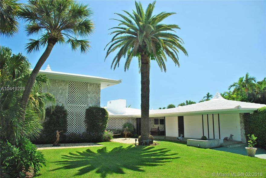 This home has been presented in many distinguished publications for its unique design. Standing proudly at the tip of a guard gated island. With a Caribbean beach house feel it is surrounded by 162 ft of open waterfront. Unique in design with floor-to-ceiling glass, beautiful Brazilian walnut floors, a large pool, exquisite coral patio, outdoor bar, cabana, dock & boatlift, full house generator & 2 car garage. Located in an exciting area of Miami, surrounded by a vibrant arts and design scene.