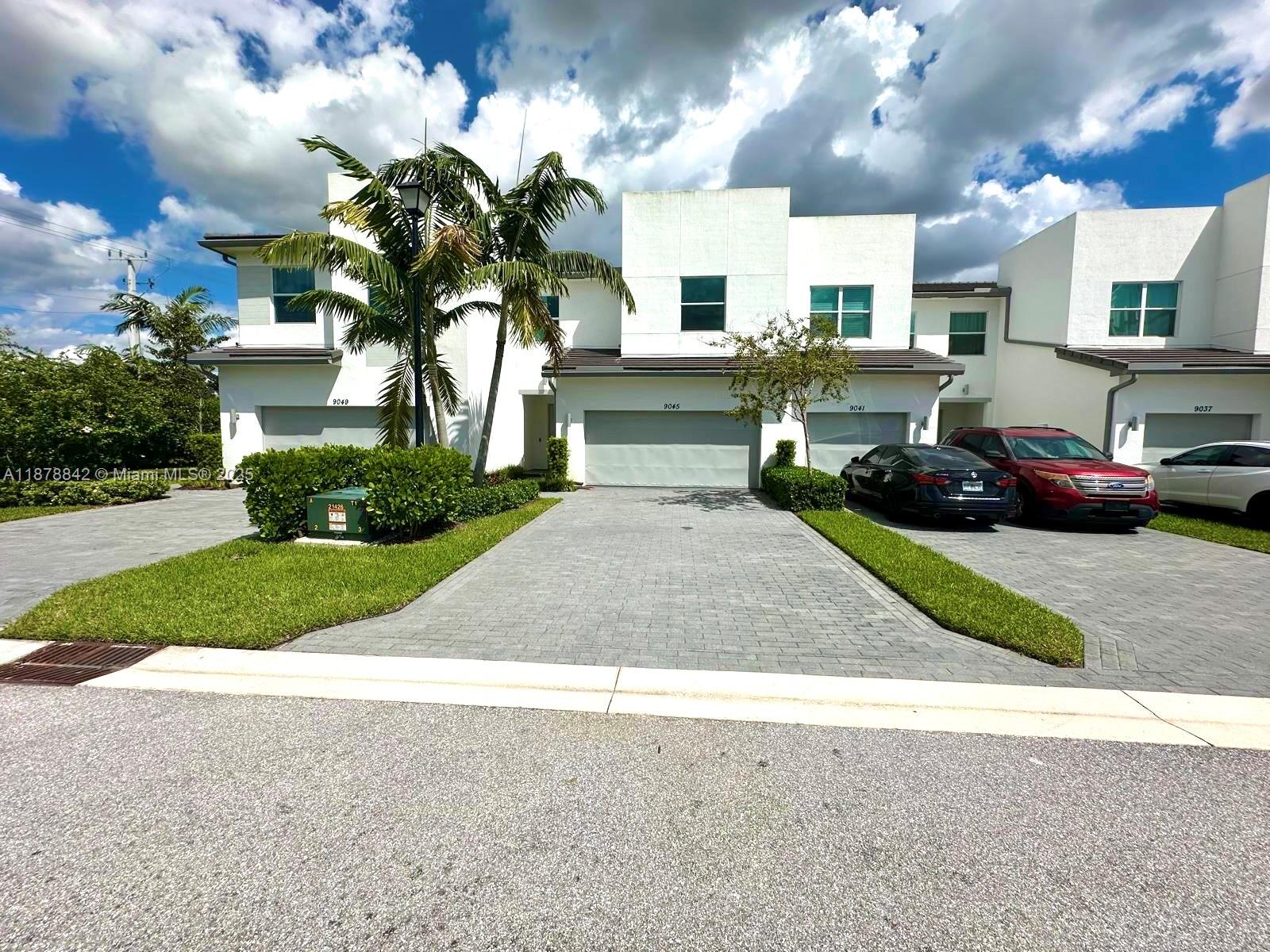 NO HOA approval process!! Quick move-in :) This LARGE LUXURY townhome comes with a wide foyer and open layout. The soaring 24 ft ceiling above the staircase, wood-look plank tile floors, wood cabinetry ,QUARTZ counter tops and STAINLESS STEEL appliances create a beautiful upgraded space. All 3 bedrooms are upstairs with a large laundry room. Lots of storage throughout. Impact windows & Doors & backyard space for your convenience. LAWN CARE included! This a secure community with GATED ENTRY. Other amenities include pool, gym, bbq area etc. Check out the schools! :) 2 min away from the Turnpike. Easy access to shopping & dining!