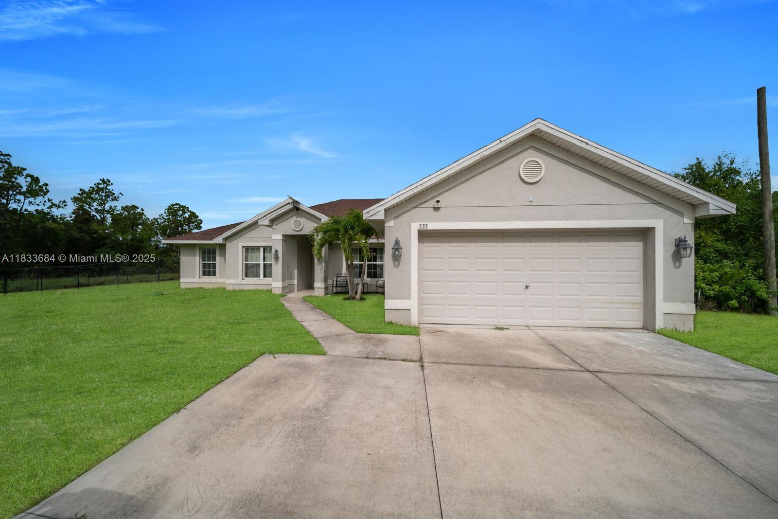 Beautiful ranch-style home on a 1-acre lot in Lehigh Acres’ desirable Greenbriar area.
This spacious 4-bedroom, 2-bath home includes a den/office, 2-car garage, and extended driveway for up to 6 cars. Inside, enjoy a formal living and dining room, a large family room, and an open kitchen with pantry and brand-new stainless steel appliances (2025). The primary suite offers a spa-like bath and dual walk-in closets. New roof (2024), generous guest bedrooms, oversized laundry with new washer/dryer (2025), and a screened lanai perfect for outdoor living. Hurricane shutters and generator-ready panel provide peace of mind.
Don’t miss the opportunity to own this beautiful move-in-ready home, perfectly designed for comfort, style, and desirable living in a prime location.