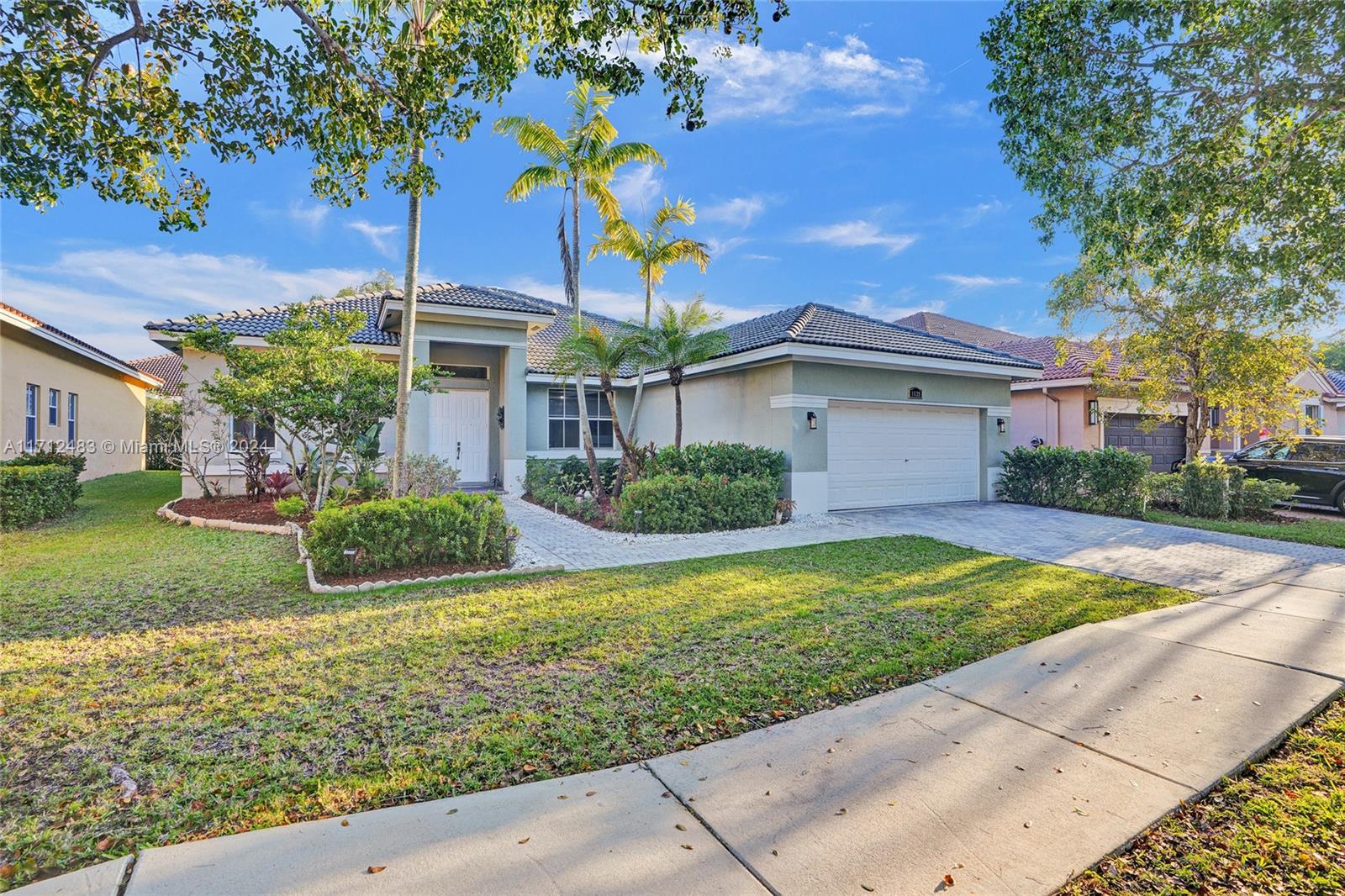 Located in Weston's Savanna Subdivision, this one-story home is the perfect blend of elegance and comfort 4/2.5. 
Inside, the main living areas boast sleek tile floors, while the beds have been recently upgraded with laminate flooring.Bright and 12 ft ceilings, large eat-in kitchen, island, lots of closet space. Master bathroom features exceptionally large walk in closets & marble baster bath. Newly updated II bathroom. You will benefit from a reduced electricity rate because the property has solar panels. community with resort like amenities, 3 pools, active club, classes, a soccer field, mini golf and more, 2 manned gates. With "A" rated schools nearby, it's a great choice for families looking for top-tier education in a welcoming community.