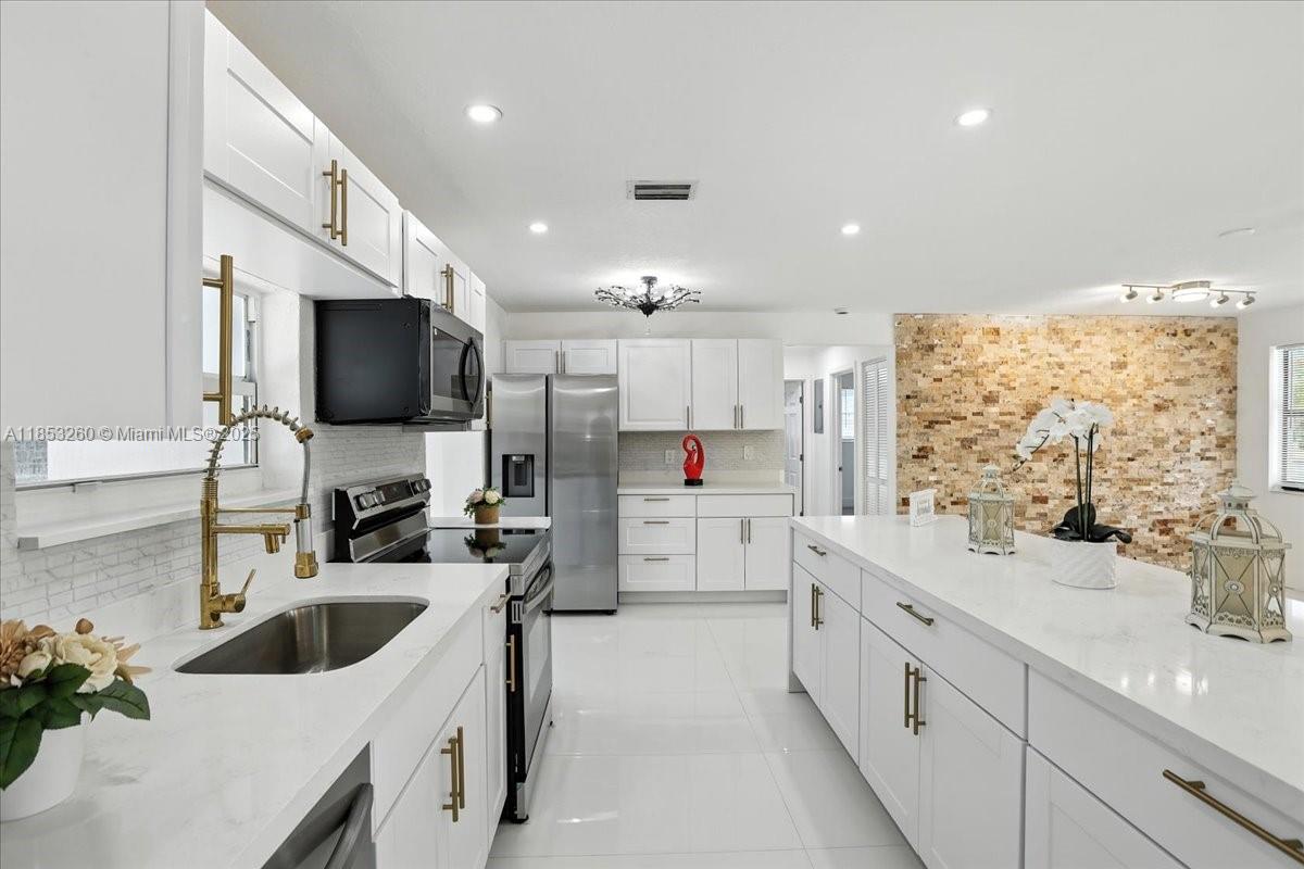 **Stunning Pool Home in Cooper City!** Prepare to fall in love with this beautifully remodeled home.This beautifully remodeled property features 3 bedrooms, 2 bathrooms, laundry room, pool and oversize yard, overlooking the canal.Step into the brand new kitchen! It boasts sleek, contemporary cabinetry, state-of-the-art appliances, & gorgeous countertops. The open layout seamlessly connects the kitchen to the inviting living area, ideal for entertaining or relaxing. Outside, you’ll find a beautiful backyard that’s perfect for soaking up the sun or hosting gatherings with friends & family. Enjoy your inviting pool on hot summer days or relax by the water—it’s your private oasis! 2019 roof, new appliances, A/C, washer & Dryer. A+Schools, a must see.