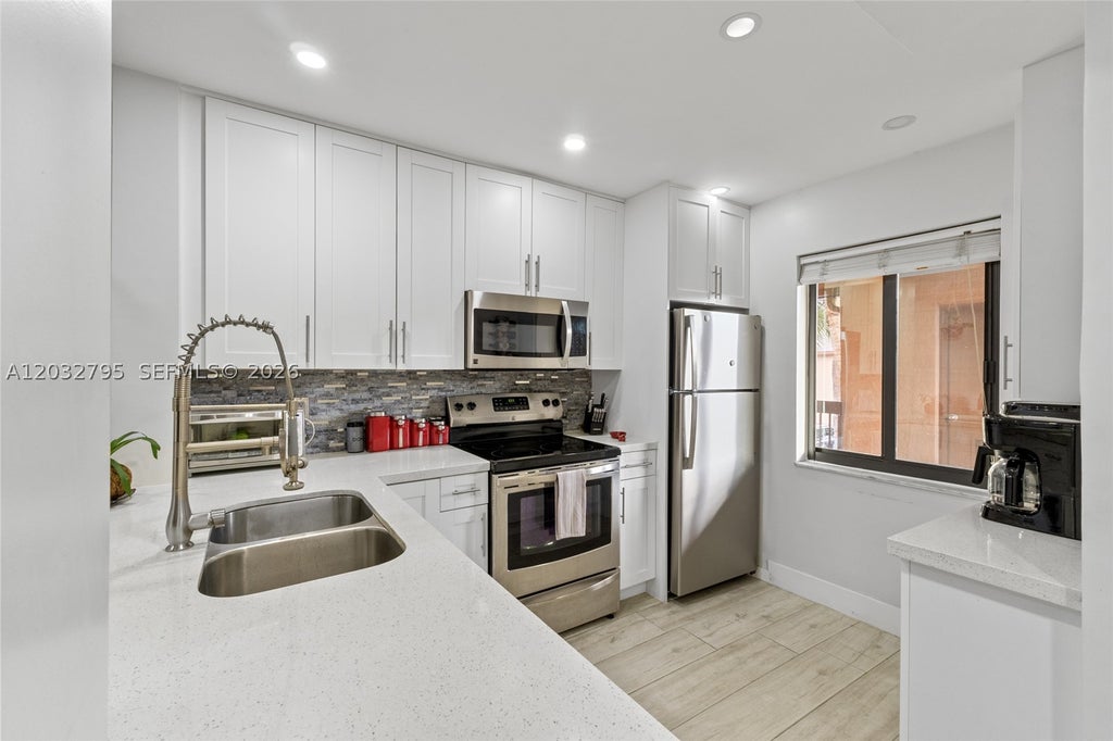 Photo of 10003 Winding Lake Rd #203, Sunrise, FL 33351 (MLS # A12032795)