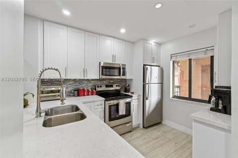 Photo of 10003 Winding Lake Rd #203, Sunrise, FL 33351 (MLS # A12032795)