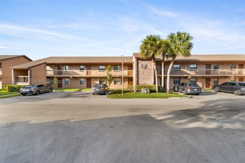 Photo of 10003 Winding Lake Rd #203, Sunrise, FL 33351 (MLS # A12032795)