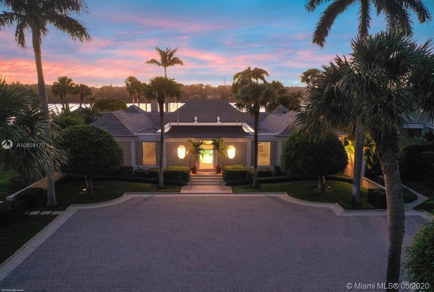 Nestled along the Intracoastal Waterway, with a total of 6-bedrooms, this courtyard-style residence offers peace and tranquility throughout its over 5,200 square feet of elegant living spaces. Impeccably maintained with sophisticated style featuring fine craftsmanship, tray ceilings and terrazzo floors. The main house surrounds a covered patio with heated pool and includes 2 bedrooms in each wing connected by a spacious living room. Flanking the living room is a formal dining room and an inviting family room/den with fireplace. The master suite is situated to take in panoramic views to the west and south. Over 2 lush acres with beautiful landscaping and a vast lawn that sweeps down to 217± of protected shoreline. 2-bedroom guesthouse and a 2-car garage with ample storage for 2 golf carts.