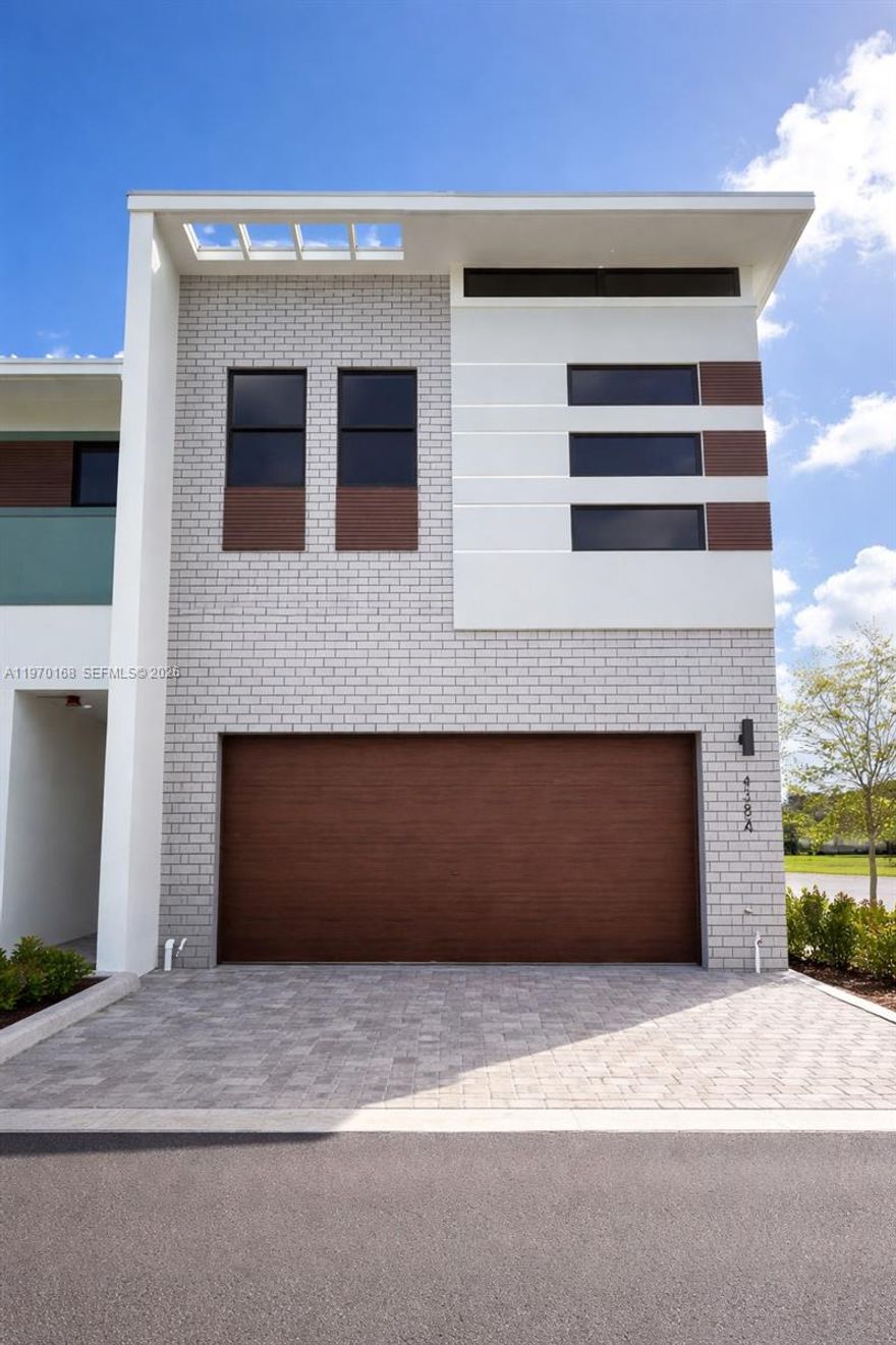 Stunning lakefront corner townhouse located in the newest phase of Strata at Plantation. Built in 2022, this residence offers a bright, open floor plan enhanced by volume ceilings, refined kitchen cabinetry, a spacious center island, and a seamless layout ideal for  everyday living. Thoughtful design and quality finishes are showcased throughout, including elegant wood-plank tile on the staircase and across the entire upper level, delivering the warmth of hardwood with the durability of tile for a polished, cohesive look. The second floor features an open den area, perfectly suited for a home office. Recessed lighting is installed throughout the main living areas and all bedrooms. The primary suite, complete with its own private balcony, serves as a retreat with a beautifully upgraded shower and striking white textured designer tile accents. A patio overlooking the lake provides a cozy setting Additional highlights include motorized blinds, built-in speakers in the main living area, a smart home automation system for lighting and blinds with Alexa integration, digital entry, and custom built-in closet systems in the primary closet as well as in both secondary bedroom closets. Corner homes with direct lake panoramic are rarely available, offering a unique opportunity to privacy, refined design, and a tranquil lakefront lifestyle.