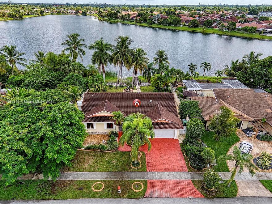 Beautiful 3 bedroom, 2 bath home featuring a versatile Flex room that can be used as an office or an additional bedroom. The property offers a spacious covered terrace with a stunning full lake view, visible from multiple areas of the home, surrounded by mature palm trees. Additional features include a 2 car garage and ample space for comfortable living and entertaining.