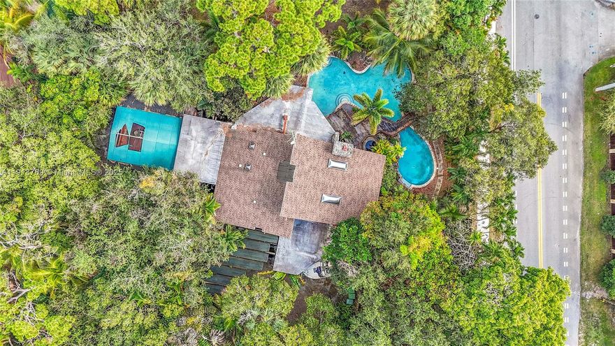 This home features natural cedar wood and striking architectural details, including coral rock fireplace and other natural coral accents that bring a timeless character to the interior. Plenty of natural light with multiple skylights, an atrium and a loft. It has a great floorplan for entertaining including a wet bar. Outside is a tropical oasis: free style pool and spa, massive deck and lush landscaping overlooking the tranquil canal. This is indoor-outdoor living at its best. Private, peaceful and ready for gatherings.