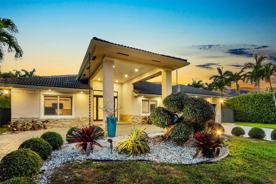 Stunningly updated with contemporary flair, this breathtaking four-bedroom, three-bath residence is ideally located on a private no-through street in the coveted Falls area! The light and bright home features a portico, impact windows and doors, gleaming floors, and beamed volume ceilings! The gorgeous modern kitchen is open to all main living areas and its oversized counter island is perfectly designed for entertaining. Beautiful and spacious primary  suite has patio access. The private outdoor space features meticulous landscaping, a cozy covered outdoor room patio, paver pool deck with two pool shelves for sunning, and a nice sized backyard. Turn-key ready to move in! This is the home of your dreams! A rare opportunity you won't want to miss out on!