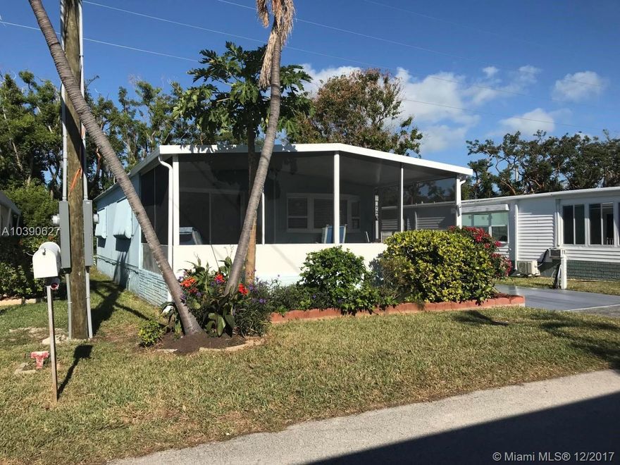 This Tropical Island Home is lovely. Beautifully upgraded with tile floors throughout, remodeled kitchen with corian counters, new screened front porch. For the most discriminating buyer and easy to see. Come live the island lifestyle in an over 55 community with boat dockage, clubhouse, heated pool, boccie, shuffle board, tennis courts. Not to be missed.