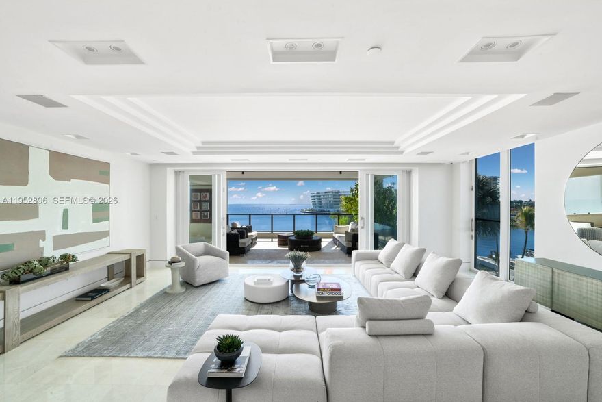 Expansive flow-through waterfront unit at the Residences at Vizcaya offering the scale and layout of a private home with the convenience of full-service amenities. Flooded with natural light and framed by sweeping Biscayne Bay views, this oversized residence welcomes you through a grand foyer into expansive open living and entertaining spaces that flow effortlessly to a large private terrace overlooking the pool and bay. The gourmet chef’s kitchen features marble countertops, custom cabinetry, an oversized island with breakfast bar seating, and top-of-the-line Miele appliances. Two expansive primary suites offer terrace access and oversized custom walk-in closets, including a main suite positioned to capture direct bay views. Two additional bedrooms complete the residence, including one with terrace access and en-suite bath, and another currently configured as an office/entertaining space. Additional highlights include private elevator entry, a staff suite with full bath and Thermador wine coolers + convenient access to the laundry room, integrated Sonos audio system, Lutron lighting, 3 assigned parking spaces, and a storage unit. Residents enjoy resort-style amenities including a private marina, lap pool with cabanas, jacuzzi, two spas, state-of-the-art fitness center, social club room, and an approximately 5,000 SF private botanical garden.