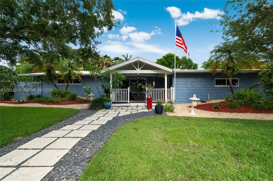 Looking to live in a move-in ready home in the Village of Pinecrest?  Look no further, pride of ownership exudes in every corner of this home.
As you drive up you are greeted by an inviting Key West style front porch perfect for lazy summer afternoons, a good book, and a glass of homemade lemonade. Other features include: large kitchen with island including granite counters and SS appliances, upgraded bathrooms, highly desirable and hard to find Cuban tiles in common areas, large great room perfect for family gatherings, split floorplan, primary bedroom with access to a quiet outdoor lanai perfect for a cup of coffee before the start of a busy day, oversized office next to primary bedroom, east facing covered terrace, screened pool overlooking a tranquil, manicured, professionally landscaped backyard.  In addition, impact glass, newer metal roof, side entrance double garage, and so much more.
Call today for a private appointment Do not miss this enchanting, unique home.
