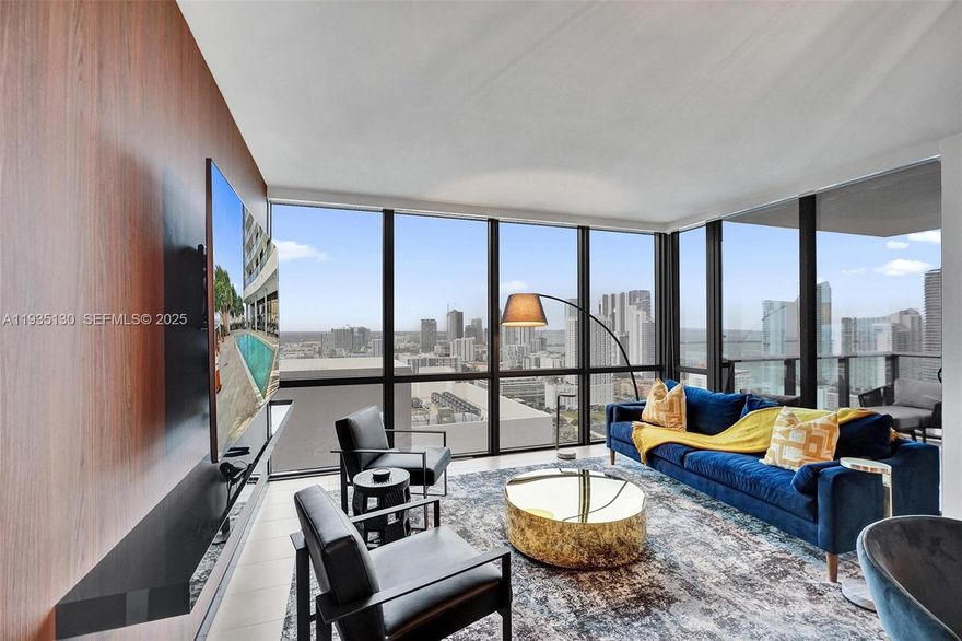 Indulge in refined Miami luxury at Canvas Miami with this exceptional 2-bedroom, 2-bath residence, offered fully furnished and masterfully designed by acclaimed interior designer Steven G. This sophisticated home showcases curated furnishings, striking artwork, and a seamless blend of modern elegance and coastal glamour. Expansive glass doors lead to a generous balcony capturing breathtaking sunrises and sunsets over the Intracoastal and Miami skyline. Canvas delivers a true resort lifestyle with multiple skyline pools, rooftop plunge pool, fitness center, yoga garden, theater, racquetball court, sauna, and sundeck—set moments from Downtown, Edgewater, and Biscayne Bay. Designed for the discerning buyer seeking style, views, and effortless luxury.