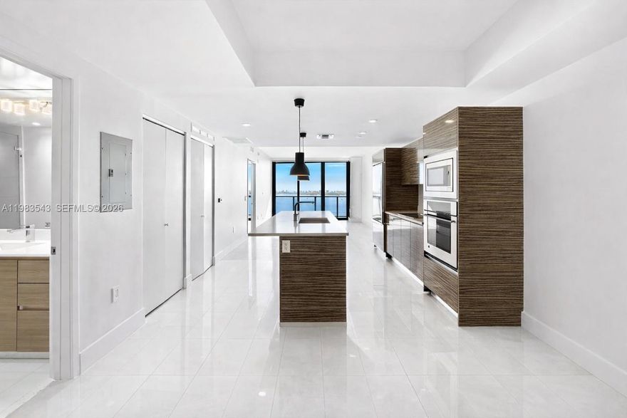 Experience the pinnacle of Edgewater luxury in this designer-inspired, 2-bedroom, 2-bathroom sanctuary perched on the 14th floor of the prestigious Icon Bay. Spanning 1,095 square feet of sleek living space, this residence features a private foyer, Italian porcelain floors, custom closets, and designer lighting throughout. Floor-to-ceiling windows flood the open-concept layout with natural light, showcasing breathtaking, direct panoramic views of Biscayne Bay from every room and your private balcony. The primary suite serves as a refined retreat with an en-suite bath and high-end window treatments. Residents enjoy five-star, resort-style amenities, including an infinity-edge bayfront pool, state-of-the-art fitness center, spa, tennis courts, theater room, and a private waterfront park with curated art installations. Strategically located just minutes from the Design District, Wynwood, and Midtown, with Whole Foods and elite dining just around the corner. Unit includes one assigned parking space, 24/7 concierge, and valet service.