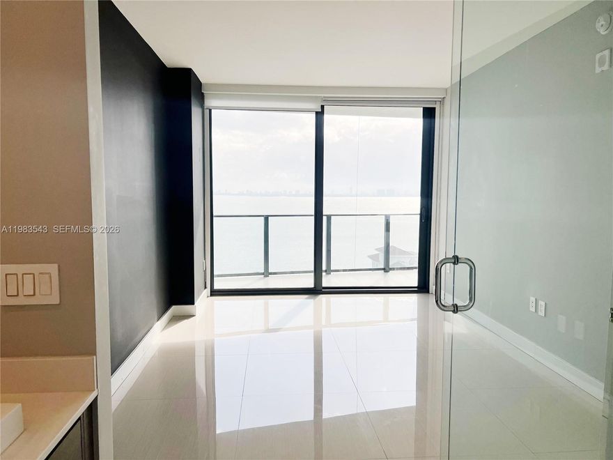 Experience the pinnacle of Edgewater luxury in this designer-inspired, 2-bedroom, 2-bathroom sanctuary perched on the 14th floor of the prestigious Icon Bay. Spanning 1,095 square feet of sleek living space, this residence features a private foyer, Italian porcelain floors, custom closets, and designer lighting throughout. Floor-to-ceiling windows flood the open-concept layout with natural light, showcasing breathtaking, direct panoramic views of Biscayne Bay from every room and your private balcony. The primary suite serves as a refined retreat with an en-suite bath and high-end window treatments. Residents enjoy five-star, resort-style amenities, including an infinity-edge bayfront pool, state-of-the-art fitness center, spa, tennis courts, theater room, and a private waterfront park with curated art installations. Strategically located just minutes from the Design District, Wynwood, and Midtown, with Whole Foods and elite dining just around the corner. Unit includes one assigned parking space, 24/7 concierge, and valet service.