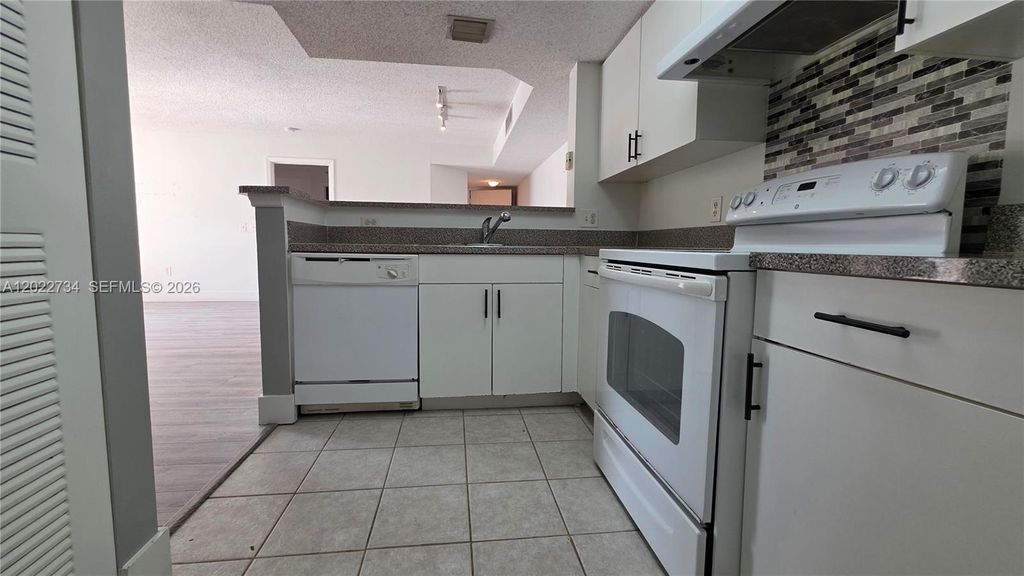 Photo of 5011 Wiles Rd #203, Coconut Creek, FL 33073 (MLS # A12022734)