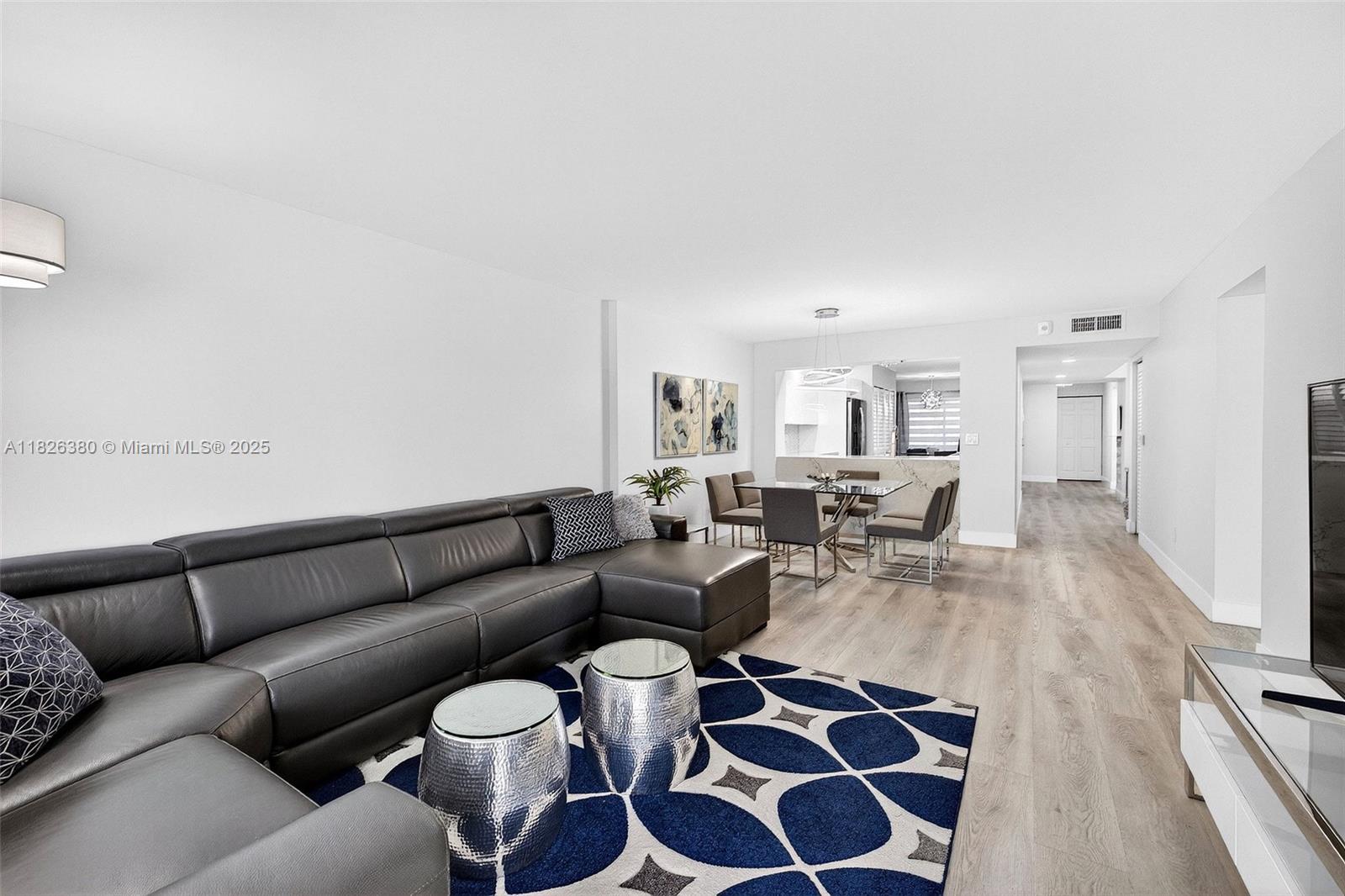 Beautifully renovated corner end unit offering modern finishes, quartz counters & an open, airy layout. One of the largest 2BR/2BA floorplans (2nd biggest in building), 2nd floor in elevator bldg. Enjoy a peaceful front patio & breathtaking panoramic lake views from the oversized screened-in back patio. Spacious Den/Office area. Sunlight pours in through sliding glass doors in both living room & primary. Renovated 4–5 yrs ago including appliances. A/C 2023. Features SS appliances, LVP Flooring, tile in bathrooms,, full impact glass, accordion shutters for patios. 55+ guard-gated Kings Point Tamarac w/ clubhouse, pools, spas, theater, tennis, pickleball & more. Pride of Ownership shows in the amazing unit.