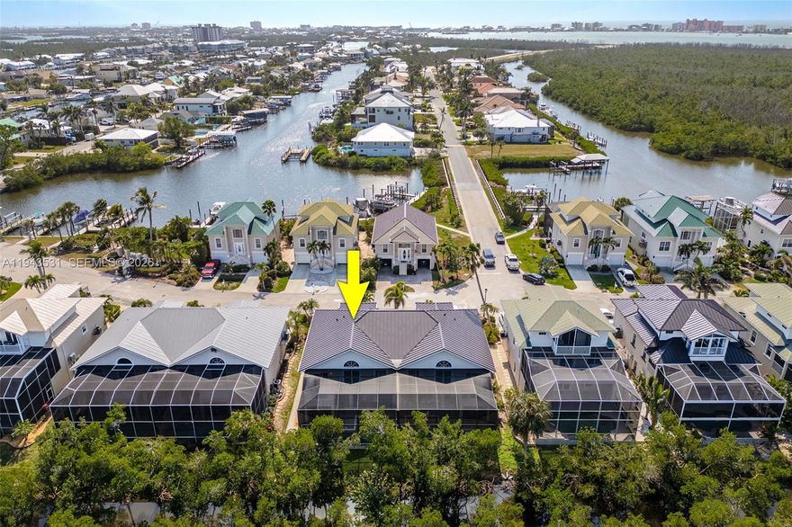 Best-priced concrete block (CBS) waterfront villa in Fort Myers Beach, located in the desirable Old Pelican Bay community and offering the rare advantage of TWO docks. This hurricane-proven, two-story villa sustained no hurricane damage, with all main living areas elevated on the second floor for added protection, views, and coastal breezes. Recent upgrades include a 2024 metal roof, 2024 HVAC, 2023 hot water heater, and 2023 pool equipment, plus a 1-year home warranty. The light-filled open layout features serene water views, a private primary suite, guest bedrooms with ensuite baths, an upstairs balcony, and a private pool. Dock #16 includes a 10,000-lb boat lift, offering easy Gulf access for boating and fishing, while a transferable flood policy (~$1,200/year) enhances affordability. Just minutes from Fort Myers Beach, dining, shopping, and entertainment—this is a rare opportunity to own a durable, low-maintenance waterfront villa with exceptional value.