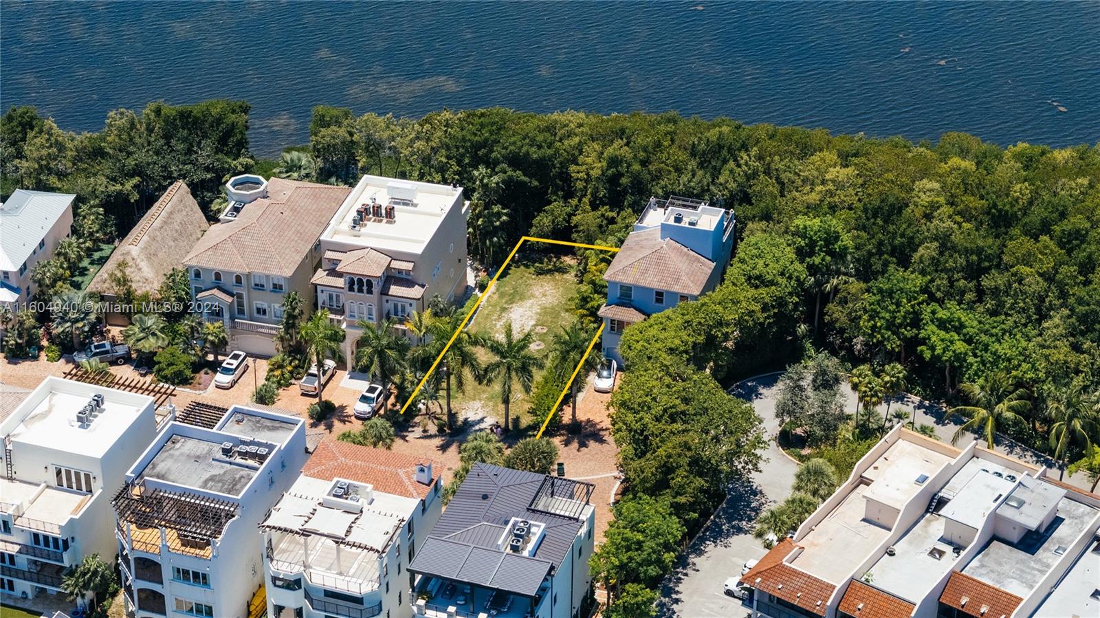 Amazing opportunity to build your dream home on this beautiful bayfront vacant lot in exclusive Paradise Point. Experience resort-style living at its best within the private, secure community of Royal Harbor Yacht Club. Enjoy 24-hr security, clubhouse, two tennis courts, heated pool, gym, and private beach with volleyball court. Take a serene nature walk to the beach to enjoy the bay view or dock your boat at the full-service marina. This lot comes with complete architectural and engineering plans for a stunning 6,000sf home featuring a rooftop pool with panoramic views of southern Biscayne Bay. The plans have been approved by both the City of Palmetto Bay and the Royal Yacht Harbor Club/Paradise Point HOA. Don't miss out on this exceptional opportunity to create your own piece of paradise