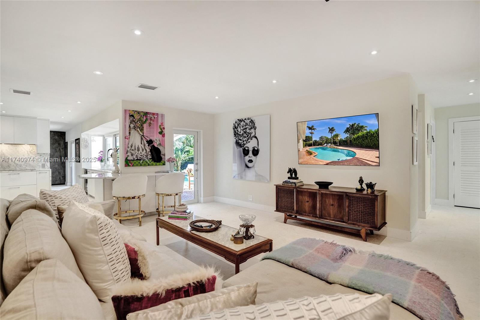 Step into this impeccably transformed 4-bed, 3.5-bath home, offering over 3,000 SF of living space filled with natural light. Situated diagonally across a double corner lot on the most desirable street in Hollywood Lakes, every detail blends elegance and function—honored travertine floors, a chef’s kitchen with GE Monogram appliances, crystal waterfall counters, custom closets, and high-end finishes. The spa-inspired primary suite features an outdoor soaking tub, creating a serene retreat that opens to a lush backyard oasis. Perfect for entertaining, the in-ground pool and L-shaped lanai complete the space. A 500 SF insulated 2-car garage, smart home features, and energy-efficient systems elevate this home. Walk to Hollywood Circle, beach, and Broadwalk in minutes. This stunner has it all.
