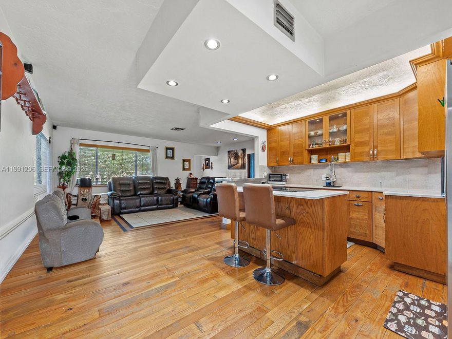 NO HOA! Enjoy the peace of a quiet neighborhood in this move-in ready 3 bedroom, 2 bathroom home. This property is built to last with a durable metal roof, impact windows and doors and features a sleek interior with stainless steel appliances and a mix of tile and wood floors, NO CARPET! Previous copper piping in restrooms have been converted to PVC pipes, offering peace of mind. Enjoy the covered backyard and host memorable family gatherings! Home also has a convenient carport, with the potential of being closed off to create additional space. You are minutes away from groceries, dining, parks and schools, making everyday life easy and convenient. The perfect home for those seeking a low maintenance lifestyle without any restrictive rules.