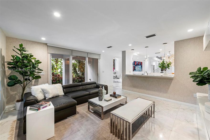 Stunning Grove Gem! This spectacular & dramatic modern residence designed w/ a distinctive functioning floor
plan features the finest luxurious appt w/ current modern comforts for a tropical lifestyle! Concrete roof, soaring
ceilings, marble & wood floors. Gourmet dream kitchen. 2nd floor private family quarters w/ 4 bedrooms.
Luxurious baths. High-impact windows & doors. Open lush vistas from every room! Additional office, patio.
Rooftop inviting pool & 800 SF deck! ELEVATOR, 2 car garage. Additional parking inside the gate. Outdoor cabana bath. Lush landscaping. This elegant home is superbly located in S. Grove; walk to the town center of Grove for shopping, fine dining & entertainment! Excellent schools nearby! Over 4500 SF of luxury living! Broker's Remark for showing instructions.