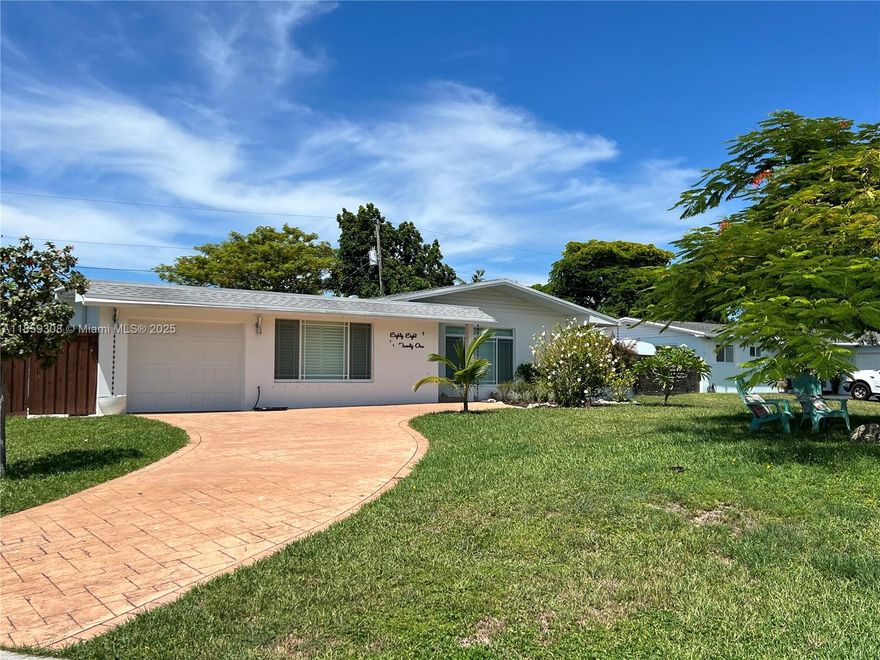 Located in coveted Whispering Pines, this beautifully updated 3-bed, 2-bath home set on an elevated corner lot offers the perfect blend of style & comfort. The bright, open layout is anchored by a stunning new chef's kitchen featuring quartz countertops & ss Kitchen Aid appliances. Recent upgrades include newly added media & laundry rooms, & gas-powered water heater, dryer and oven for efficiency. Step outside to a sparkling pool set within a lush, wrap-around backyard featuring a spacious, pre-wired shed that adds versatility for storage and space for a boat.  The garage is equipped with storm-rated insulated doors & its own AC, ideal as a studio or gym. Directly across from the lake, a popular area during the holiday season, & steps from top-rated schools and Black Point Marina.