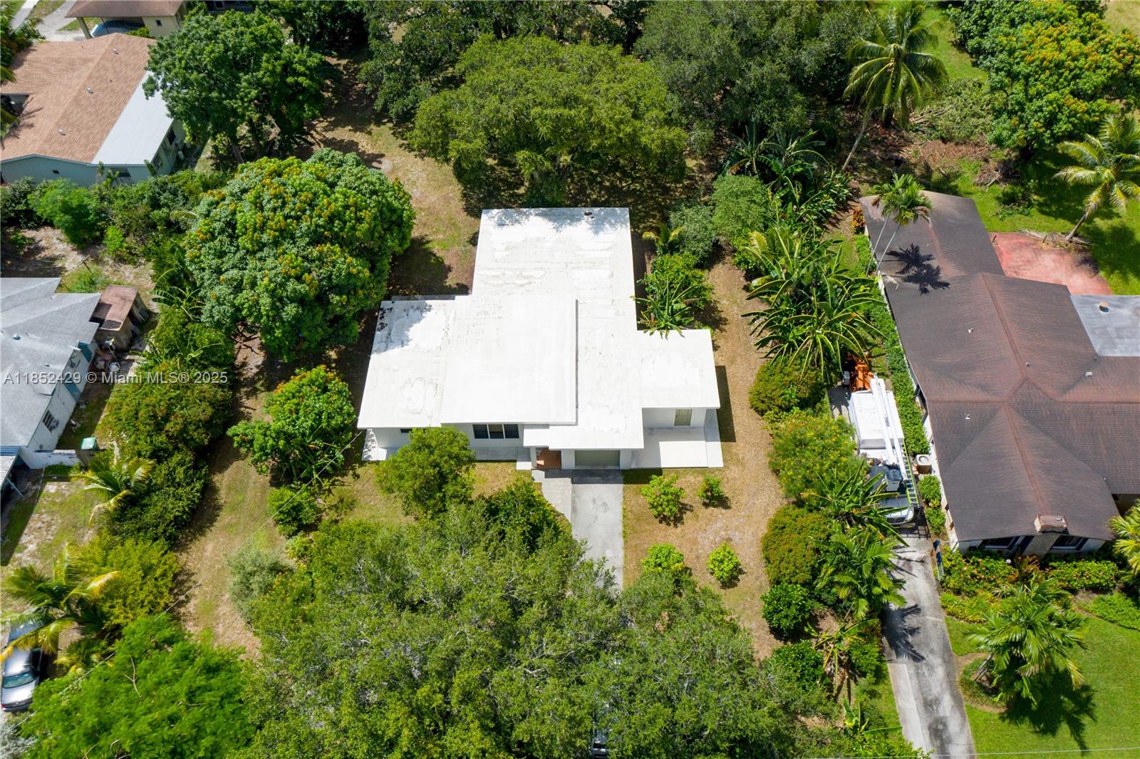 Welcome to a great midcentury home in the heart of it all! Nestled on a 1-acre lot, this 3-bedroom, 2-bath home offers a blend of privacy, comfort, and convenience. Mature oaks provide shade and charm, thoughtfully trimmed away from the roof. Step inside to a remodeled kitchen with high end appliances, and updated bathrooms that add a fresh feel. A generous Florida room opens to the yard with many mature fruit trees, including mangoes, soursop, and bananas. Additional highlights include a newer roof and impact windows throughout. Located in a established neighborhood that feels tucked away yet is just minutes from Aventura, the beaches, Wynwood, and downtown. This home is a rare find, offering both space and serenity in the heart of unincorporated Miami-Dade.