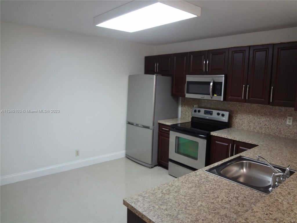 Photo of 10125 W Sunrise Blvd #104, Plantation, FL 33322 (MLS # A11340103)