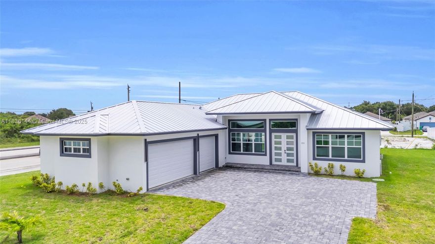 Luxury living custom built 2024 home, loaded w premium features + high end finishes. Perfectly located near I-95 and Turnpike, close to top rated schools, parks and hospitals. Entire home w sleek 24x48 Porcelain tile, gourmet kitchen w solid wood shaker cabinets, quartz countertops, cooktop, hood, microwave/oven combo, premium stainless steel appliances, modern baths w porcelain tiles, custom accent wall featuring fireplace and built in tv panel. CGI Sentinel series impact insulated sliding doors/windows. Foam insulation for energy efficiency. Built in wood in closets and pantry. Covered back porch w porcelain tile and tongue-and-groove wood ceiling. Brick paver driveway. Fully landscaped yard w St Augustine sod w irrigation. This home combines modern luxury exceptional craftsmanship.