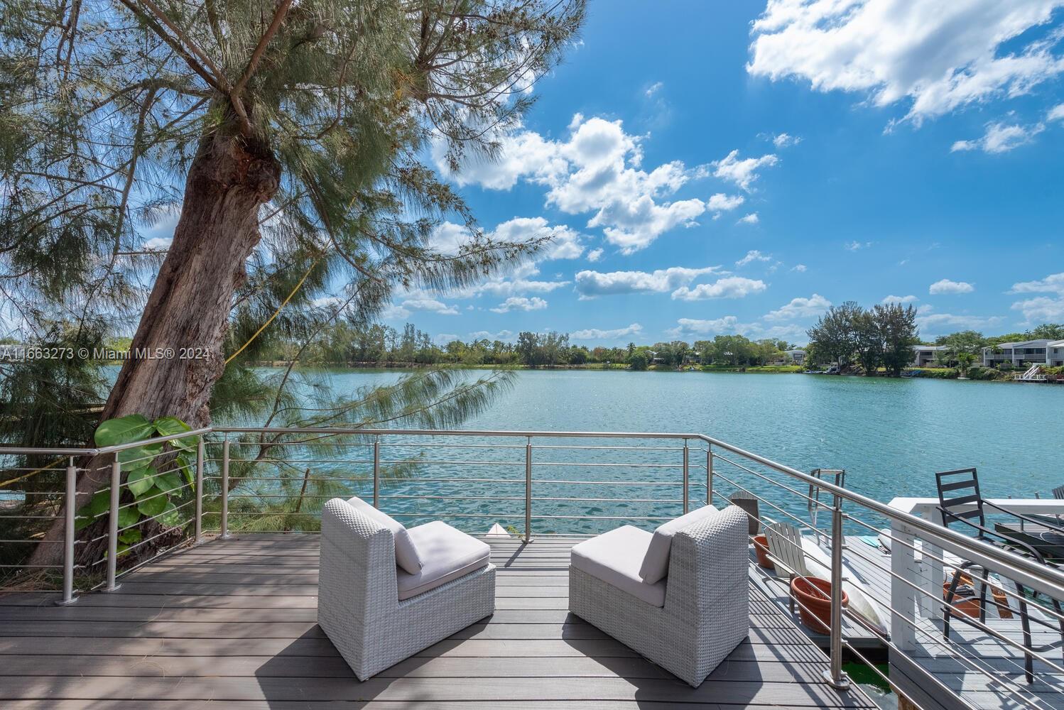 Welcome to your serene lakeside haven home! This exquisitely remodeled Townhome in a gated community offers unparalleled waterfront lifestyle. This beautiful 3bed /2.5 bath home includes a canoe stored on your own private dock, resting on a swimmable lake, ensuring endless adventures on the water. A view of the lake from kitchen, living room, master bathroom, and master bedroom creates amazing ambiance of peace and relaxation. Lakeridge has so much to offer, including: two pools, tennis/pickleball courts, nature trail, butterfly garden, playground, and an array of community events. Impact windows all throughout, sliding windows in living room open to an amazing deck with delightful views of the lake.