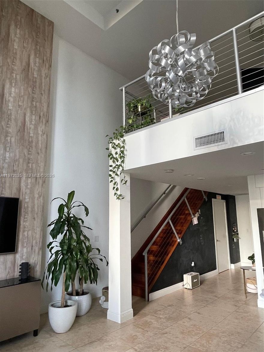 Experience elevated urban living in this stunning loft featuring a bright, open-concept design with dramatic double-height ceilings and sleek porcelain flooring throughout. Natural light floods the space, enhancing the modern aesthetic and airy feel.
The upper level offers a private primary bedroom retreat, a versatile den thoughtfully converted into an oversized custom walk-in closet, and a full bathroom. On the main level, enjoy a spacious living and dining area perfect for entertaining, an open kitchen with upgraded white quartz countertops, and a second full bathroom for added convenience. Step out onto your private balcony — ideal for morning coffee, evening relaxation, or hosting guests.
Located just steps from Mary Brickell Village, Brickell City Centre, and the Metro-Mover, this residence offers unbeatable walkability and access to world-class dining, shopping, and entertainment in one of Miami’s most desirable neighborhoods.
A perfect opportunity for end-users or investors seeking style, location, and value in the heart of Brickell