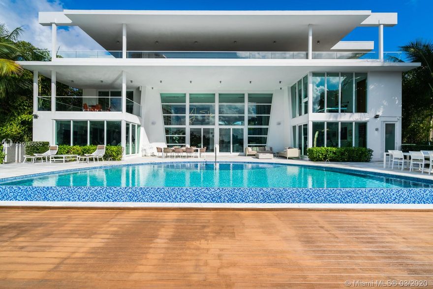 Spectacular modern 10,000 SF waterfront residence comprised of 3 full floors all with stunning direct views to the intercostal. This estate’s outdoors boast 120ft of waterfront, an infinity pool, and a large recreation area for more than 100 people in the garden, perfect for entertaining. Featuring 7 bedrooms, 1 main office and 8 bathrooms plus 1 powder room, this magnificent estate features: 1,600 SF main room with private terrace overlooking the intercostal, his/hers bathrooms, office & gym, sumptuous closet, custom wood closets and doors, family room with projector, 4,000 gallon saltwater fish tank, child’s playroom, white Quartz, white glass and Roberto Cavalli porcelain floors, Italian kitchen, separate Sub -Zero refrigerator & freezer, 2 wolf ovens and a separate guest room