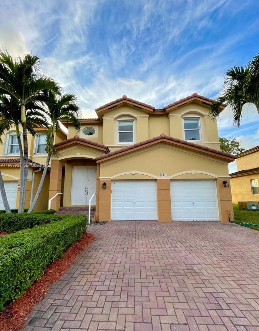 SPACIOUS 2-STORY TOWNHOUSE LOCATED AT 8666 NW 109TH CT IN DORAL WITH 2,217 SQ FT OF LIVING SPACE, FEATURING 4 BEDROOMS, 3 FULL BATHROOMS AND 1 HALF BATH, BUILT IN 2008 ON A 2,120 SQ FT LOT IN THE ISLANDS AT DORAL TOWNHOMES COMMUNITY. THIS WELL-MAINTAINED PROPERTY OFFERS TILE FLOORING THROUGHOUT THE MAIN LIVING AREAS AND WOOD FLOORING UPSTAIRS, WITH LARGE WINDOWS THAT PROVIDE ABUNDANT NATURAL LIGHT. THE LAYOUT INCLUDES OPEN LIVING AND DINING AREAS AND A KITCHEN WITH STAINLESS STEEL APPLIANCES AND A CENTER ISLAND, AS SEEN IN THE PHOTOS. THE PRIMARY BATHROOM FEATURES DUAL SINKS, A SOAKING TUB AND SEPARATE SHOWER. ADDITIONAL FEATURES INCLUDE A 2-CAR GARAGE AND A PAVER DRIVEWAY. THE FENCED BACK PATIO PROVIDES A COVERED OUTDOOR SPACE WITH VIEWS OF THE WATER, IDEAL FOR OUTDOOR USE. LOCATED IN DORAL WITHIN MIAMI-DADE COUNTY, THIS PROPERTY IS PART OF A WELL-ESTABLISHED TOWNHOME COMMUNITY.