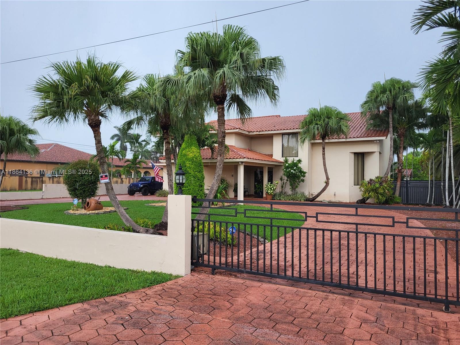 Beautiful two-story home with porte cache on a 30,492-sf estate. This home features a pool bathroom, outdoor gazebo and kitchenette/bar. The main house offers 4 beds 4 baths, formal living, dining room, gourmet kitchen, wet bar, and two family rooms. Wood Cabinets, Granite Tops, Stainless Appliances and also wide Staircase. Plenty of Closet space. Lots of potential to make it your own. Resort Style and Amenities. The Master Suite boasts a spacious layout with a sitting area, terrace, walk-in closets, and a luxurious spa-like bath. Outdoor oasis includes a large pool, and gazebo. Additional highlights: Impact Windows, Gated Property, Remote controlled Gates, 2-Car Garage, Beautiful Palm trees, Avocado tree, Lime tree and a Generous Yard .