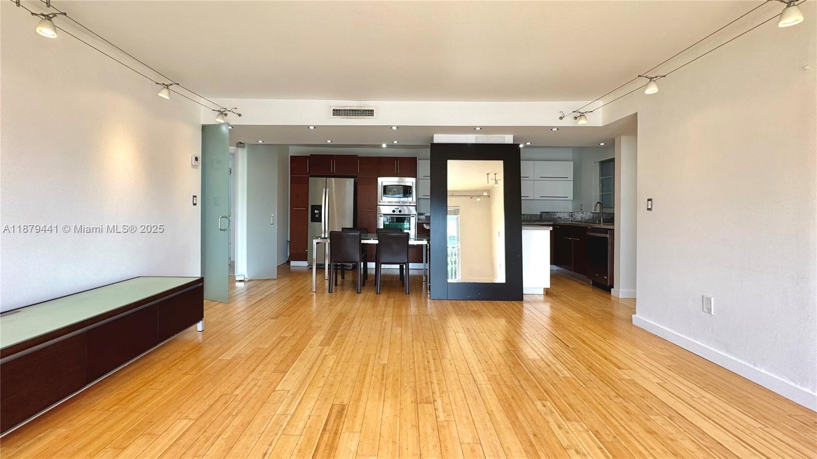 Welcome to this beautifully renovated corner unit flooded with natural light! This spacious 2-bedroom, 2-bathroom condo features a desirable split floor plan, perfect for privacy and comfortable living. The sleek, gourmet kitchen opens up to the living area, making it ideal for entertaining or enjoying a quiet night in. The primary suite includes a modern bathroom and can be closed off with chic glass doors for added seclusion. You'll love the wood floors throughout, granite countertops, stainless steel appliances, and a full-size washer/dryer for everyday convenience. This condo also comes with an assigned garage parking space, and is just a short troll to Publix, Target, 5th Street shops, and Flamingo Park.