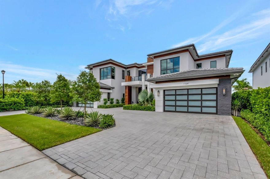 Highly upgraded, elegant estate in the sought-after Boca Bridges community offers 7,769 sq ft of living space, featuring 6 beds, 7.5 bath and a sophisticated design throughout. The home located on a spacious corner waterfront private lot (.37 acre) with only one neighbor and showcases a gourmet chef's kitchen with Sub-Zero and Wolf appliances, a spacious master suite with a spa-like bathroom and an expansive living area leading to a private outdoor oasis. Enjoy a covered patio, sparkling pool and tranquil lake views. Boca Bridges provides luxury resort-style amenities, including a clubhouse, fitness center, tennis courts all within a secure, gated community.